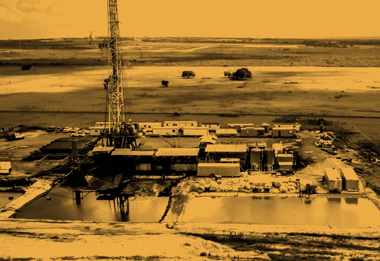 Moody yellow energy block oil and gas field with large drilling rig on company site